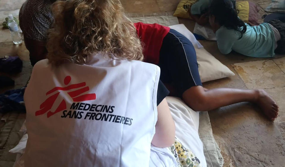 In this Oct. 8, 2018, photo provided by Medecins Sans Frontieres Australia, a patient is attended by an MSF mental health team in Nauru. Humanitarian medical professionals expelled from Nauru said on Thursday, Oct. 11, 2018, asylum seekers that Australia had banished to the tiny Pacific atoll were suicidal and their children have lost hope. The Nauru government forced Doctors Without Borders out of the country last week, abruptly ending their free medical care for asylum seekers refugees and local Nauruans. (Medecins Sans Frontieres Australia via AP)