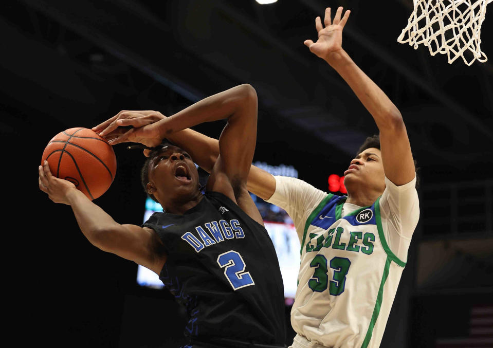 Woodward forward Ru Mills (2) is fouled by Chaminade Julienne's Jonathan Powell (33) during the Bulldogs' win in the district final, Wednesday, March 2, 2022.