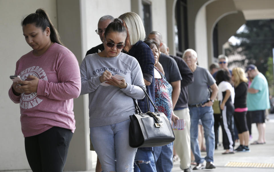 Lotto players wait in line to purchase lottery tickets for the $2.25 billion Mega Millions lottery in Sacramento, California. Source: AP Photo/Rich Pedroncelli