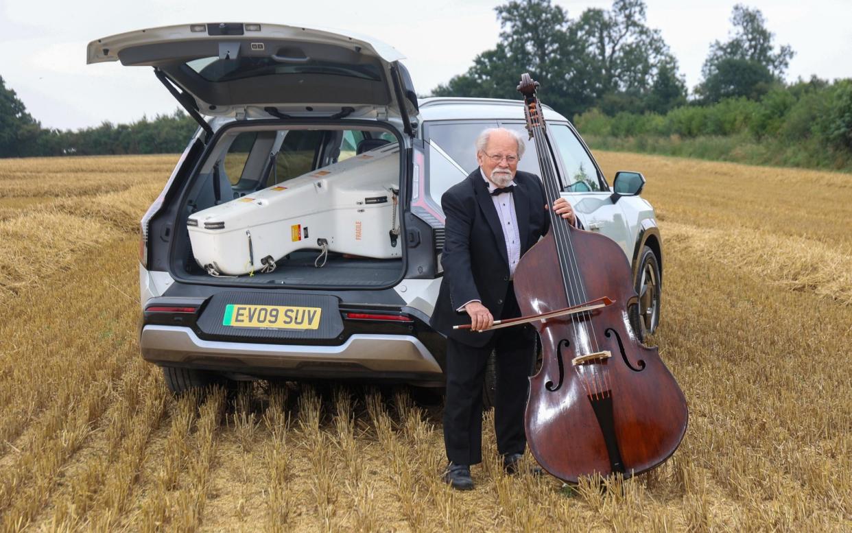 Thomas Martin with his double bass and Kia EV9