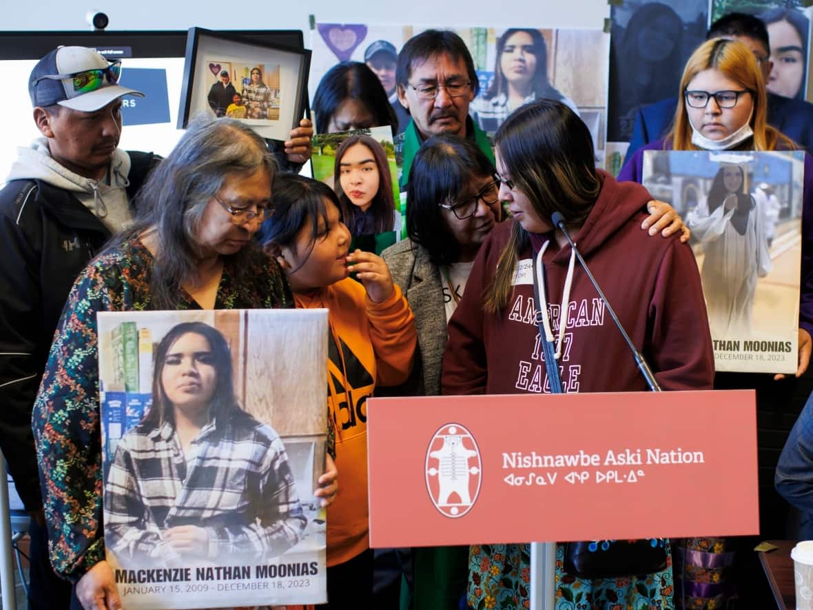Vanessa Sakanee, second from right, is comforted as she speaks about her daughter Mackenzie Moonias, a 14-year-old found dead in Thunder Bay in December 2023, during a news conference on Monday at Queen's Park in Toronto. The families are calling for the disbandment of the Thunder Bay Police Service. (Cole Burston/The Canadian Press - image credit)
