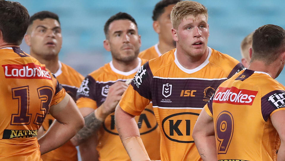 Brisbane Broncos players are pictured looking dejected during an NRL game.