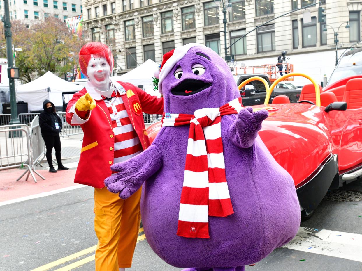 Ronald McDonald (wearing face shield) and Grimace appear in the 94th Annual Macy's Thanksgiving Day Parade¨ on November 24, 2020 in New York City.