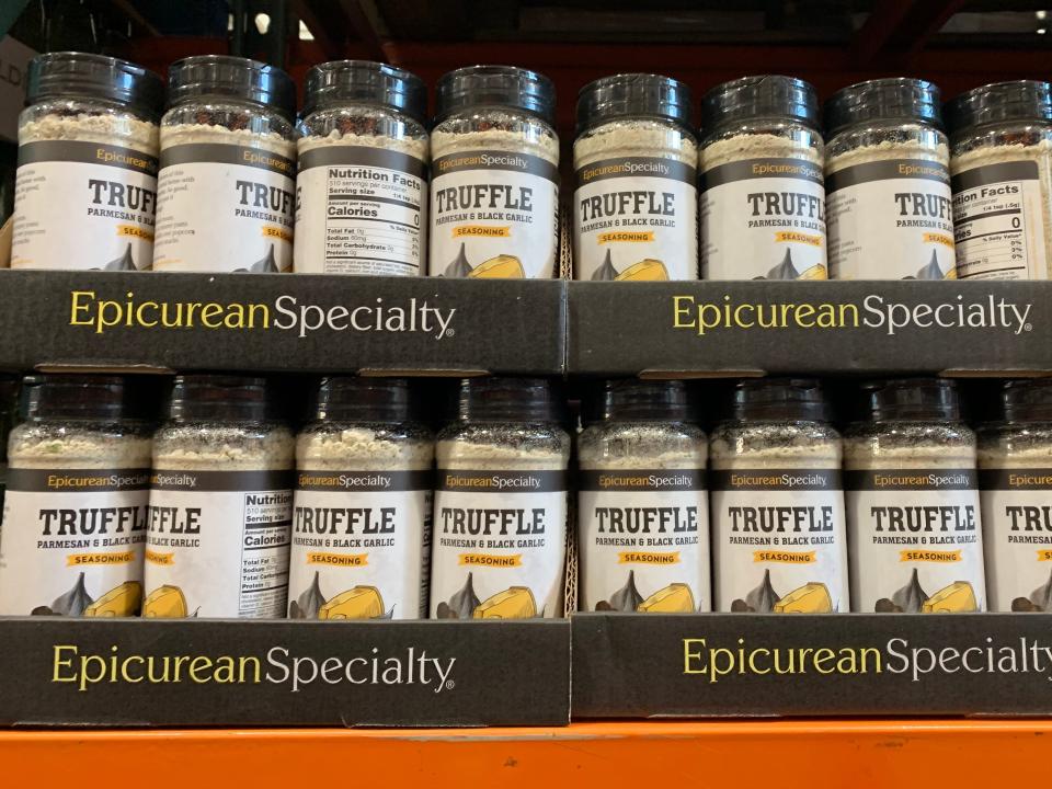 Bottles of Epicurean Specialty truffle, Parmesan, and black-garlic seasoning on display at Costco.