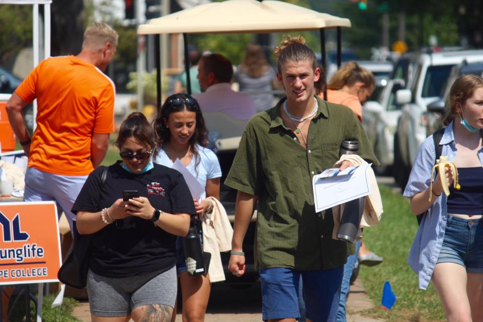 People walk on the campus of Hope College during move-in day Friday, Aug. 27, 2021.