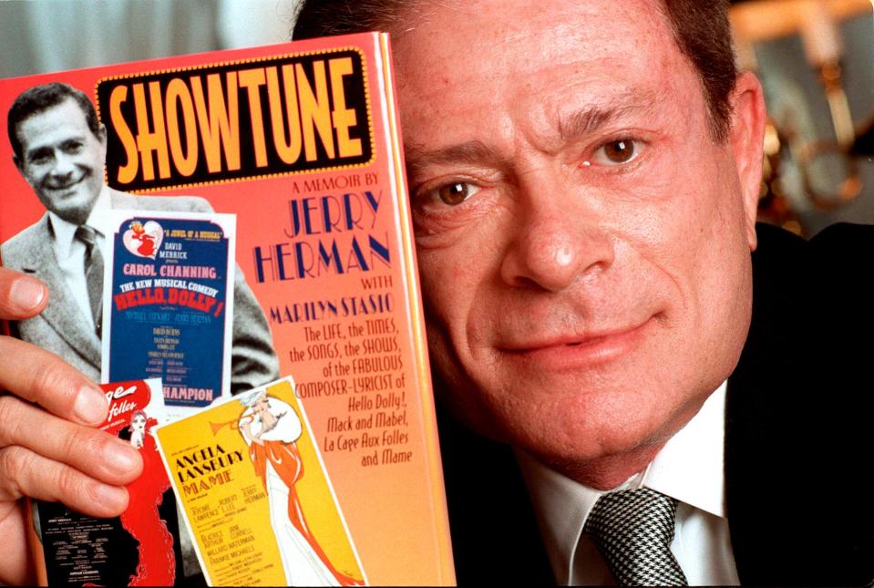 In this Nov. 19, 1996, file photo, composer Jerry Herman displays his book "Showtune," in New York. Herman, the Tony Award-winning composer behind "Hello, Dolly!," "La Cage aux Folles" and "Milk and Honey," died Dec. 26, 2019, at age 88.