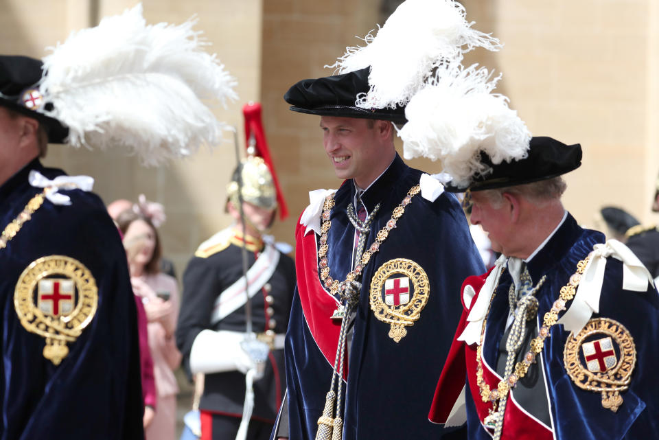 The Duke of Cambridge (centre) walks with his father the Prince of Wales (right) during the annual Order of the Garter Service at St George's Chapel, Windsor Castle.