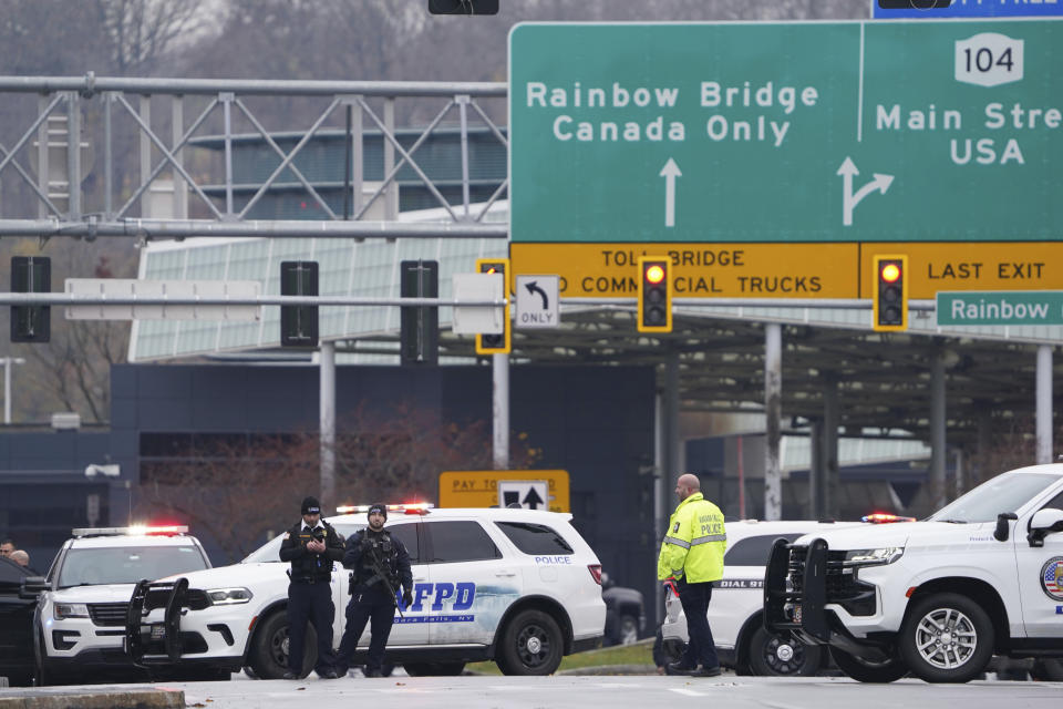 Law enforcement personnel block off the entrance to the Rainbow Bridge, Wednesday, Nov. 22, 2023, in Niagara Falls, N.Y. The border crossing between the U.S. and Canada has been closed after a vehicle exploded at a checkpoint on a bridge near Niagara Falls. The FBI's field office in Buffalo said in a statement that it was investigating the explosion on the Rainbow Bridge, which connects the two countries across the Niagara River. (Derek Gee/The Buffalo News via AP)