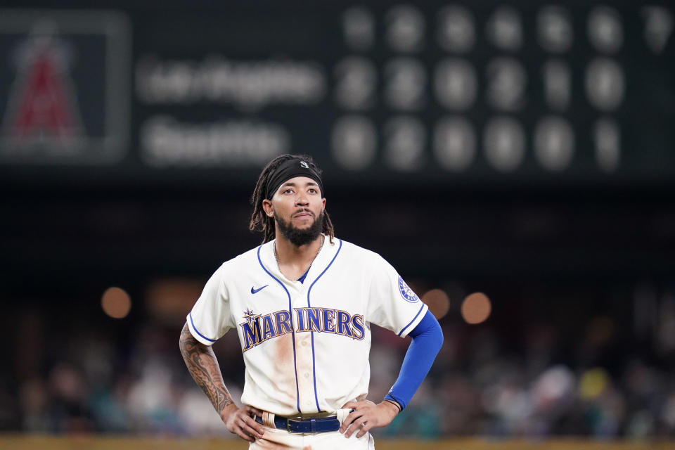 Seattle Mariners' J.P. Crawford stands on the field after being thrown out on a fielder's choice by the Los Angeles Angels to end the sixth inning of a baseball game Sunday, Oct. 3, 2021, in Seattle. (AP Photo/Elaine Thompson)