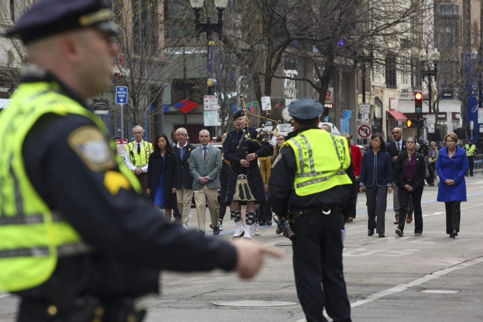 Boston Police clear Boylston Street for a procession between memorials for victims of the 2013 Boston Marathon bombing, Saturday April 15, 2023, in Boston. (AP Photo/Reba Saldanha)