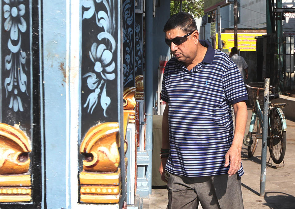 Chairman-designate of the Board of Control of Cricket in India, Narayanaswami Srinivasan, arrives at a temple to offer prayer in Chennai, India, Friday, March 28, 2014. India's Supreme Court has ordered cricket boss Srinivasan to step aside amid a corruption probe. The court said Friday test great Sunil Gavaskar should be a temporary replacement for Srinivasan to lead the Board of Control of Cricket in India until the completion of an investigation into corruption in a domestic Twenty20 league. (AP Photo/Arun Sankar K)