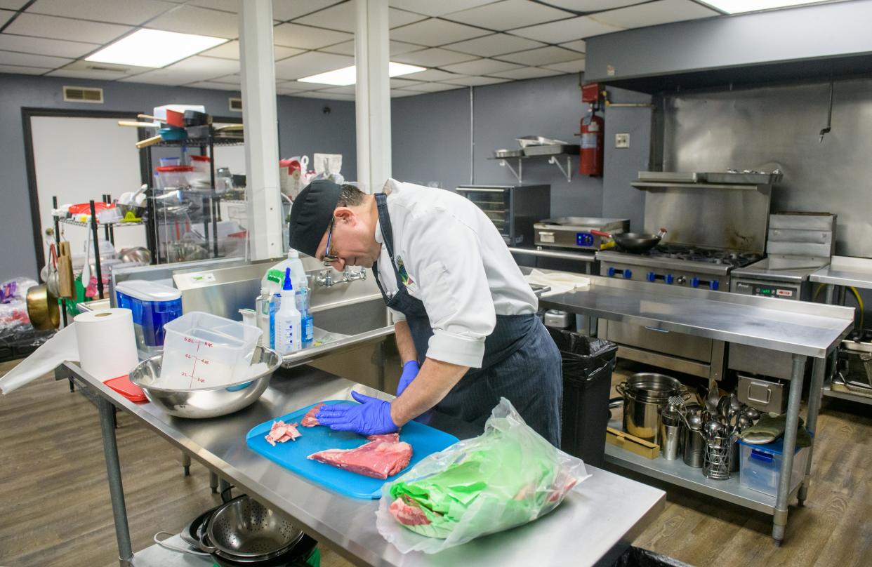 Pierre Daoud cuts meat for his shawarma dishes at Terroir 3:17 Your Home Kitchen, his Mediterranean restaurant on the square in Metamora.