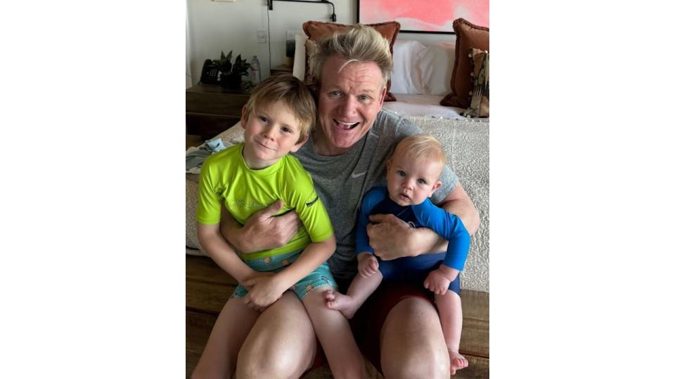 father posing for photo with two sons 