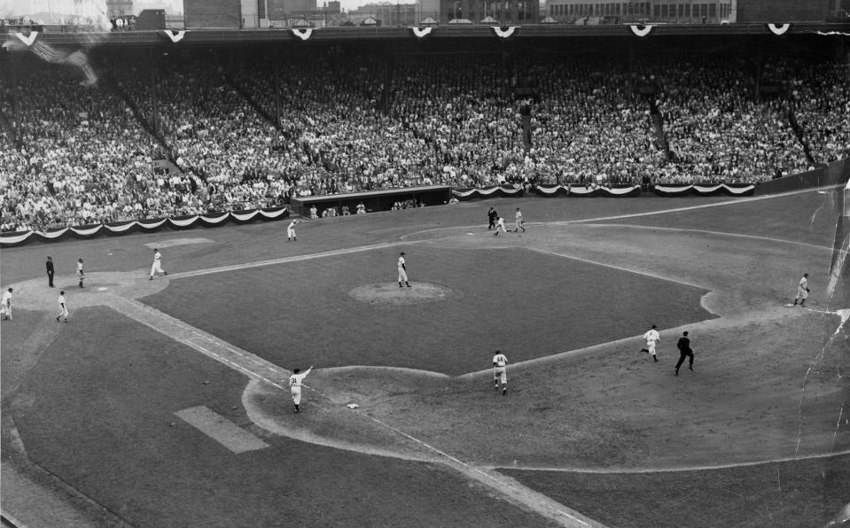 BOSTON, MA - JULY 9: Joe Gordon of the New York Yankees doubles to center field, scoring Ted Williams of the Boston Red Sox and Charlie Keller of the New York Yankees during the 7th inning of the 1946 MLB All-Star Game at Fenway Park in Boston on Jul. 9, 1946.  (Photo by Charles F. McCormick/The Boston Globe via Getty Images)