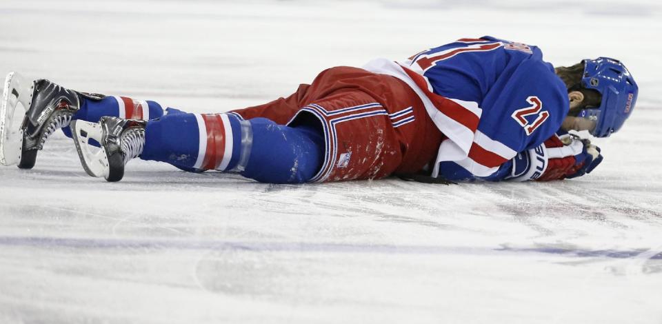 In this May 22, 2014 file photo, New York Rangers center Derek Stepan (21) lies on the ice after taking a hit from Montreal Canadiens forward Brandon Prust during the first period of Game 3 of the NHL hockey Stanley Cup playoffs Eastern Conference finals in New York. Stepan has a broken jaw and is undergoing surgery. Rangers coach Alain Vigneault made the surprising announcement Friday, May 23, 2014, on the first of two off days in the series New York leads 2-1. Prust wasn&#39;t penalized in the first period of Montreal&#39;s 3-2 overtime win Thursday night, but he faces an NHL hearing Friday and a possible suspension. (AP Photo/Kathy Willens)