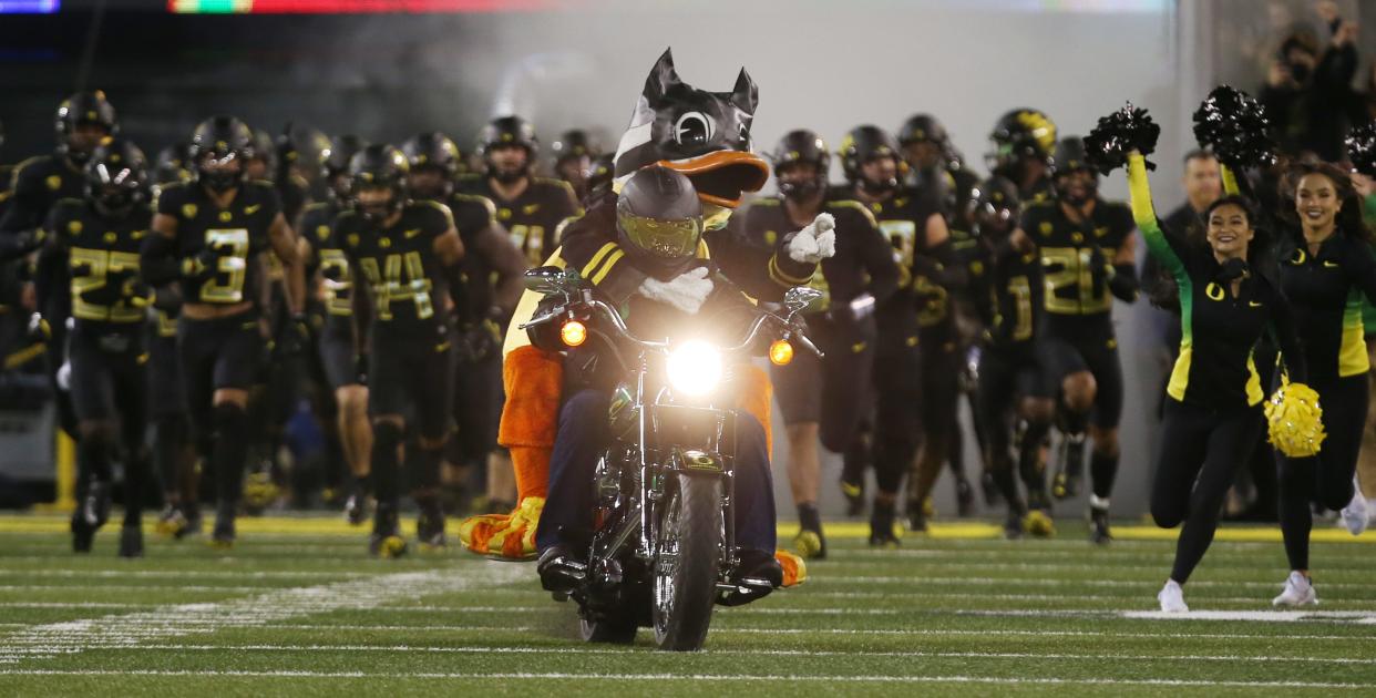 The Duck leads the team onto the field before the game against California. 