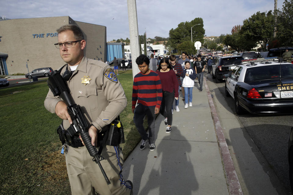 Students are escorted out of Saugus High School after reports of a shooting on Thursday, Nov. 14, 2019, in Santa Clarita, Calif. (AP Photo/Marcio Jose Sanchez)