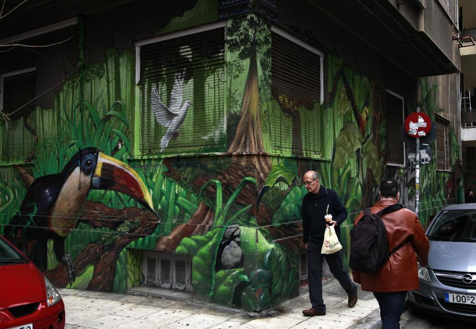 In this photo taken on Friday Feb. 21, 2014, a building front is decorated by the work of London-based street artist Alex Martinez, is seen in central Athens. Greece has attracted international street artists to its capital, due to the availability of commissioned work and relatively lax anti-graffiti law. AP Photo/Dimitri Messinis)