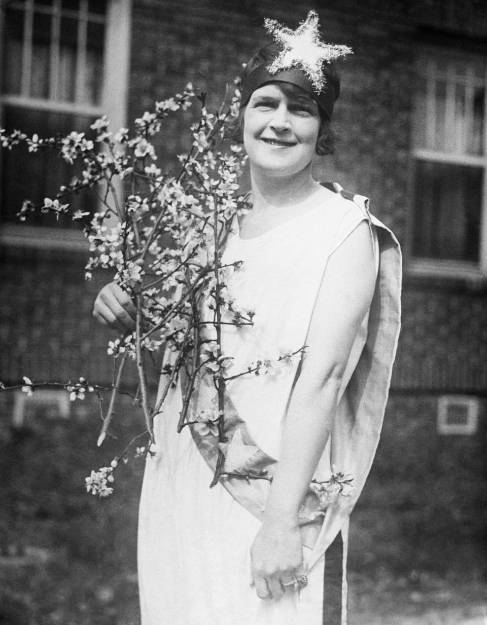 A woman dressed in a Christmas costume, circa 1920s.