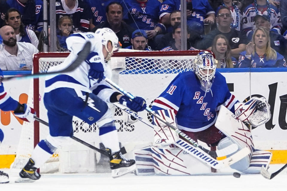 New York Rangers goaltender Igor Shesterkin (31) protects the net against Tampa Bay Lightning's Ondrej Palat (18) during the second period of Game 1 of the NHL hockey Stanley Cup playoffs Eastern Conference finals Wednesday, June 1, 2022, in New York. Palat scored a goal on the play. (AP Photo/Frank Franklin II)