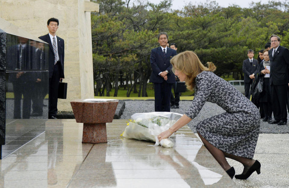 U.S. Ambassador Caroline Kennedy offers flowers in front of the National War Dead Peace Mausoleum at the Peace Memorial Park in Itoman, Okinawa Wednesday, Feb. 12, 2014. Kennedy,who arrived later Tuesday, is to meet with Okinawan officials and may see the base relocation site during her three-day visit, Kyodo News agency reported. (AP Photo/Kyodo News) JAPAN OUT, MANDATORY CREDIT