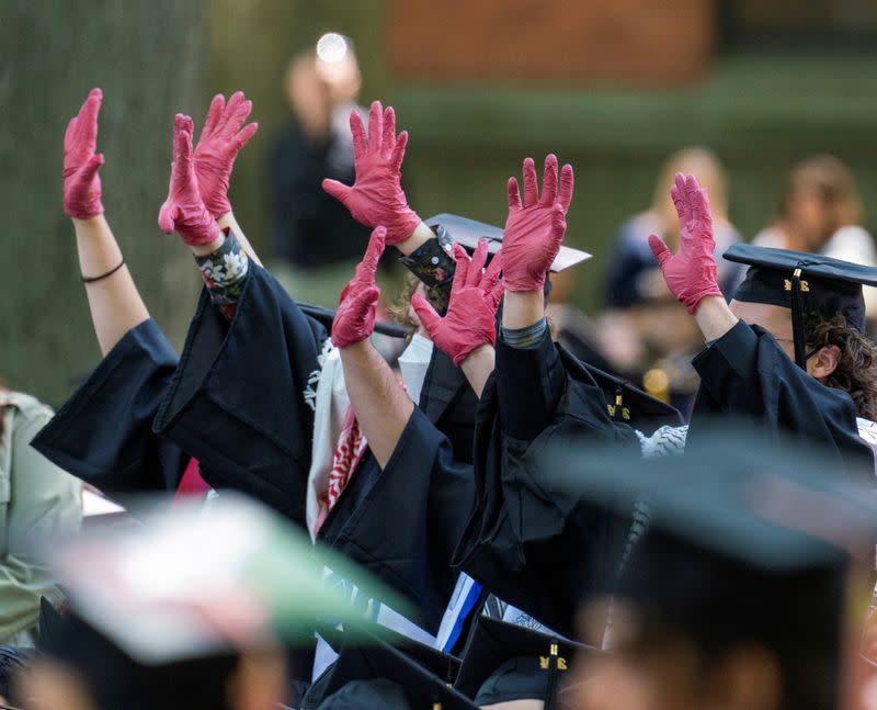 Graduates protest the conflict between Israel and the Palestinian Islamist group Hamas, during the commencement at Yale University