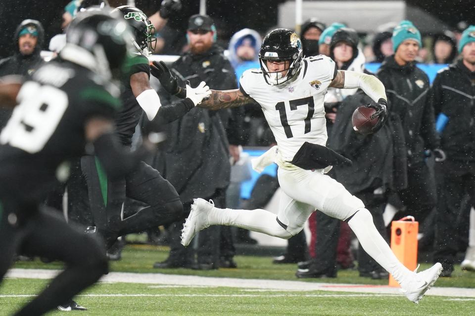 Jacksonville Jaguars tight end Evan Engram (17) carries the ball against the New York Jets during the third quarter of an NFL football game, Thursday, Dec. 22, 2022, in East Rutherford, N.J. (AP Photo/Frank Franklin II)