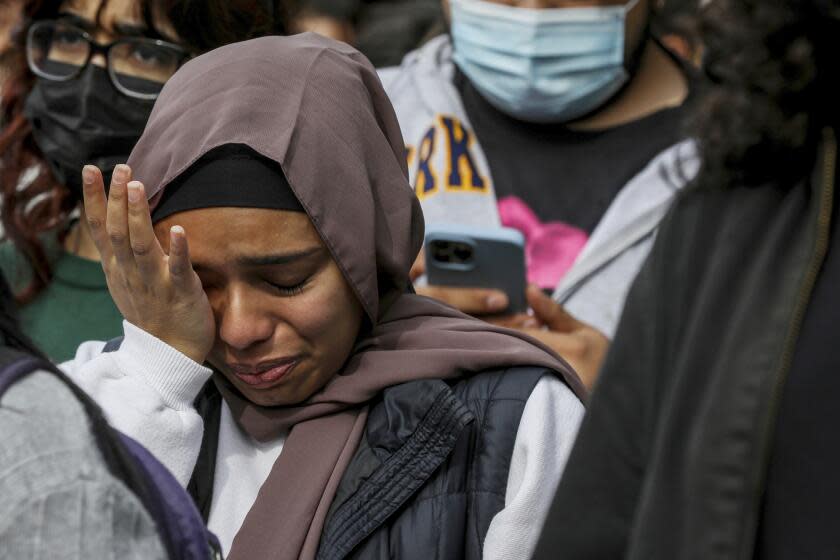 A student, who chose to withhold her name, cries while listening to the names of Palestinians killed as hundreds of people, mostly students, gather to call for a cease-fire in Gaza, during a protest on the UC Berkeley campus in Berkeley, Calif. on Thursday, Nov. 16, 2023. (Brontë Wittpenn/San Francisco Chronicle via AP)