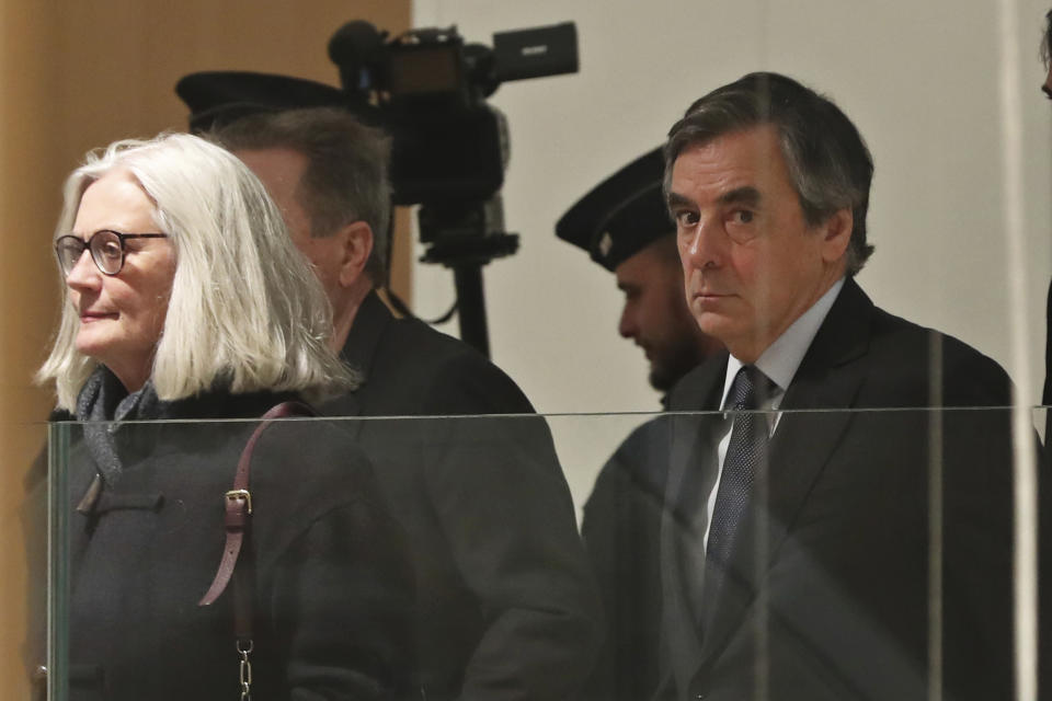 France's former Prime Minister Francois Fillon, right, and his wife Penelope arrive at the Paris courthouse, in Paris, Monday, Feb. 24, 2020. He could have been president of France. Instead, former Prime Minister Francois Fillon is going on trial to face fraud charges after he used public funds to richly pay his wife and children for work they allegedly never performed. (AP Photo/Thibault Camus)