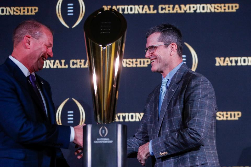 Washington head coach Kalen DeBoer, left, shakes hands with Michigan head coach Jim Harbaugh during the CFP National Championship head coaches news conference at Liberty Hall in Houston on Sunday. They will face each other Monday night.