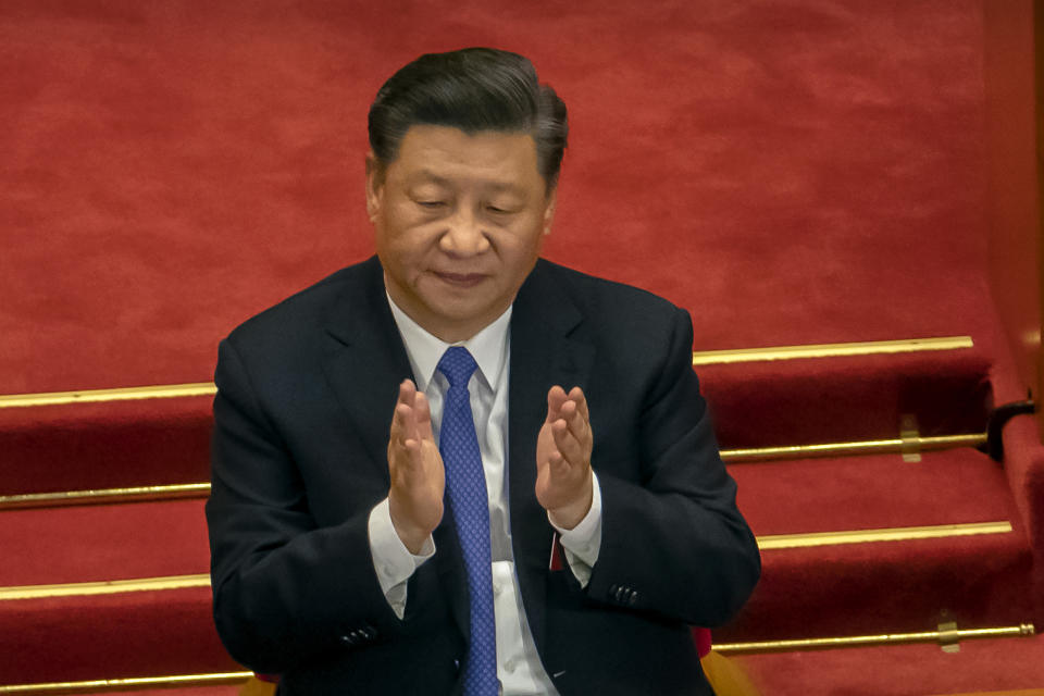 FLE - In this May 28, 2020, file photo, Chinese President Xi Jinping applauds during the closing session of China's National People's Congress (NPC) in Beijing. The ruling Communist Party is celebrating the official end of extreme poverty in China with a propaganda campaign that praises Xi’s role, part of efforts to cement his image as a history-making leader who is reclaiming his country’s rightful place as a global power. (AP Photo/Mark Schiefelbein, File)