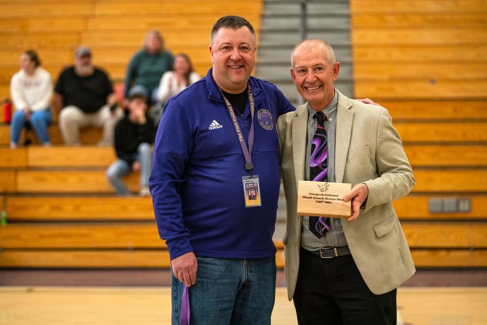 Fort Collins High School boys basketball head coach Bruce Dick is honored by athletic director Kyle Tregoning for his 700th career win during a basketball doubleheader in Fort Collins on Saturday.