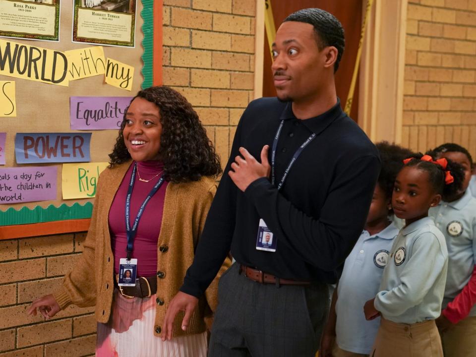 Janine and Gregory looking surprised in front of a group of students in blue uniforms on "Abbott Elementary"