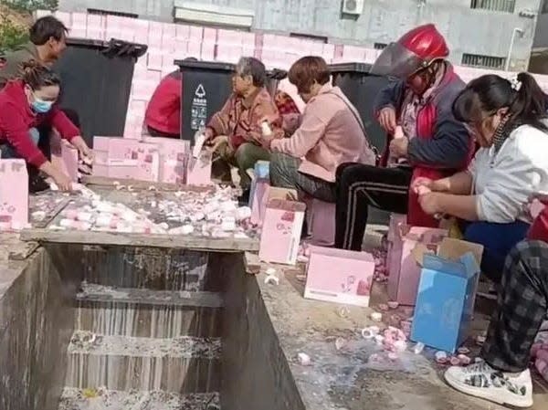 People pouring milk into the drain