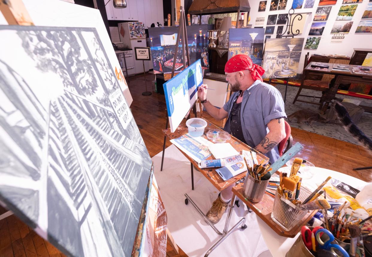 Alex Minturn, owner of Alexander's Art House in Canton, works on a piece that will be exhibited at Saturday's Meyers Lake Park Tribute Art Show.