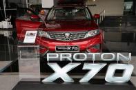 A man enters a Proton X70 car at its headquarters in Subang Jaya