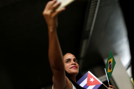 A Cuban doctor takes a selfie as she returns to her home, after criticism by Brazil's President-elect Jair Bolsonaro towards Cuban doctors prompted Cuba's government to sever a cooperation agreement, in Brasilia, Brazil November 22, 2018. REUTERS/Adriano Machado