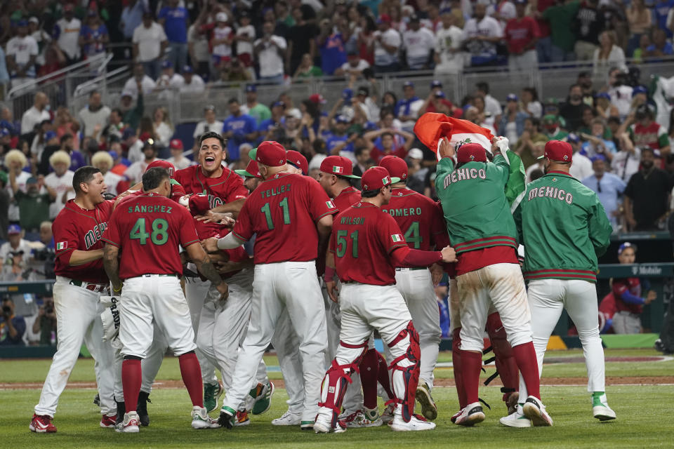 FILE -Mexico players celebrate after defeating Puerto Rico 5-4 at a World Baseball Classic game, Friday, March 17, 2023, in Miami. Major League Baseball is heading south of the border again to play a regular season series. After previous stops in Monterrey, Mexico City will be the host this time, and the timing seems perfect. (AP Photo/Marta Lavandier, File)
