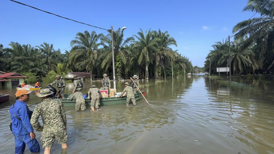 Army transport aids on a flooded road at Lengga town in Johor state, Malaysia, Tuesday, March 7, 2023. Malaysian police have found the body of a young woman trapped in a car that was swept away by rushing waters, the fifth death of seasonal floods that have also forced more than 43,000 people to flee their homes. (AP Photo)