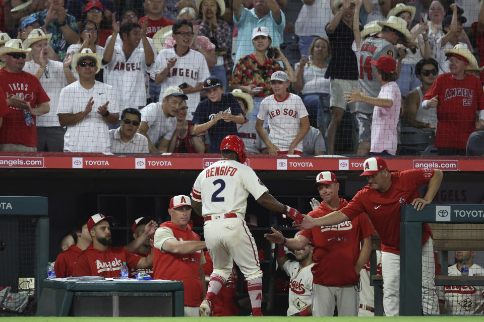 Los Angeles Angels second baseman Luis Rengifo, bottom center, celebrates with teammates after scoring a run during the seventh inning of a baseball game against the Houston Astros Saturday, Sept. 3, 2022, in Anaheim, Calif. The Angles won 2-1. (AP Photo/Raul Romero Jr.)