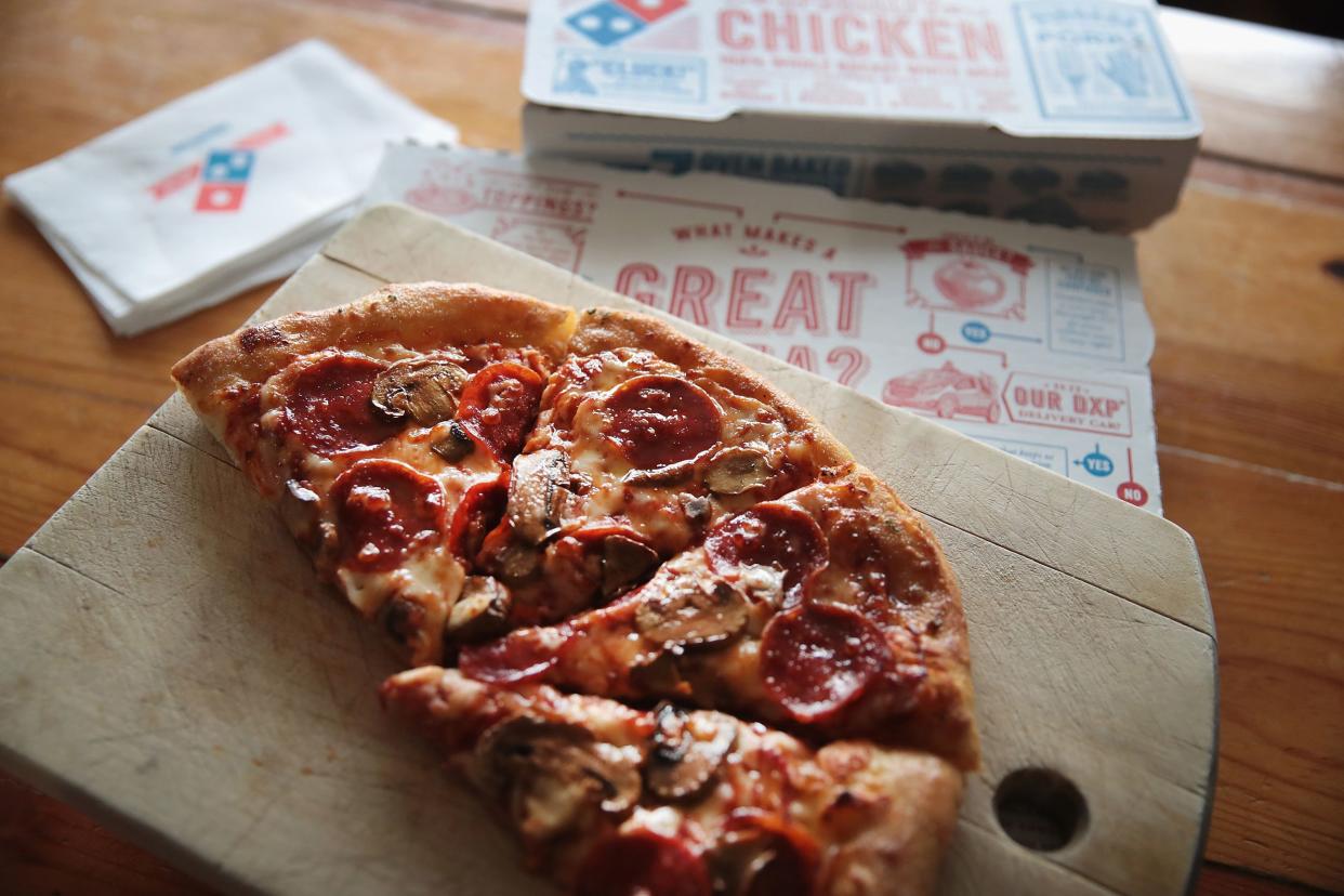 Domino's pizza with box on table