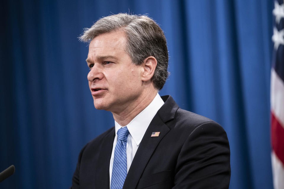 FBI Director Christopher Wray speaks during a virtual news conference at the Department of Justice, Wednesday, Oct. 28, 2020 in Washington. The Justice Department has charged eight people with working on behalf of the Chinese government to locate Chinese dissidents and political opponents living in the U.S. and coerce them into returning to China. Five of the eight were arrested Wednesday morning. (Sarah Silbiger/Pool via AP)