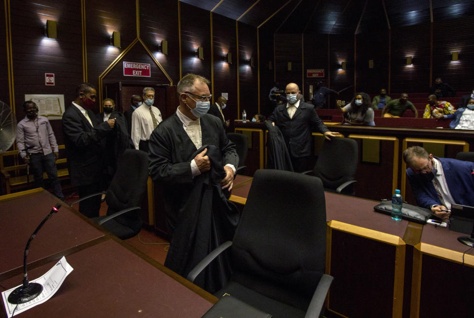 Legal teams arrive at the High Court in Pietermaritzburg, South Africa, Tuesday, Feb. 23, 2021. A South African judge said he will file a criminal complaint against former South African president Jacob Zuma after he staged a dramatic walkout while attending a commission of inquiry looking into corruption during his tenure from 2009 to 2018. (AP Photo/Themba Hadebe)