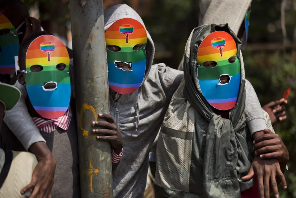 Kenyan gays and lesbians and others supporting their cause wear masks to preserve their anonymity as they stage a rare protest against Uganda’s tough stance against homosexuality and in solidarity with their counterparts there on Feb. 10, 2014 outside of the Uganda High Commission in Nairobi, Kenya. (Photo by AP Photo/Ben Curtis, File)