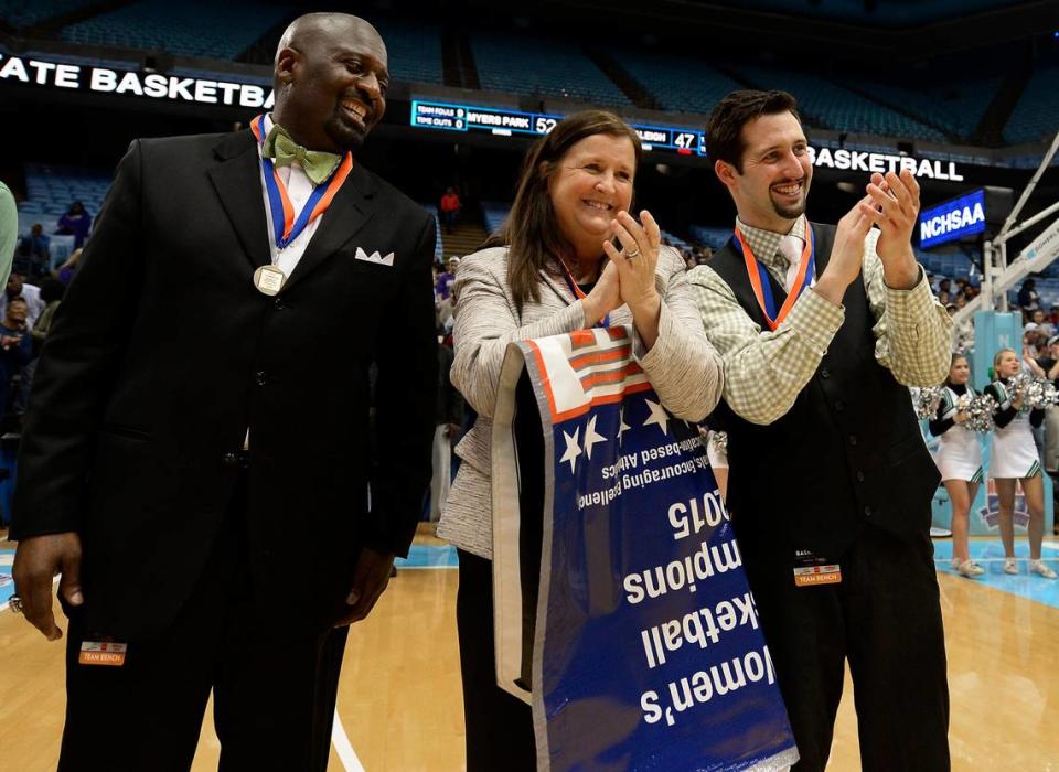 (Center) Myers Park Mustangs head coach Barbara Nelson applauds as players receive their metals following their victory over Southeast Raleigh in the NCHSAA 4A Girls Championship game at the Dean E. Smith Center in Chapel Hill, NC on Saturday March 14, 2015. Myers Park defeated Southeast Raleigh 52-47. Jeff Siner/jsiner@charlotteobserver.com