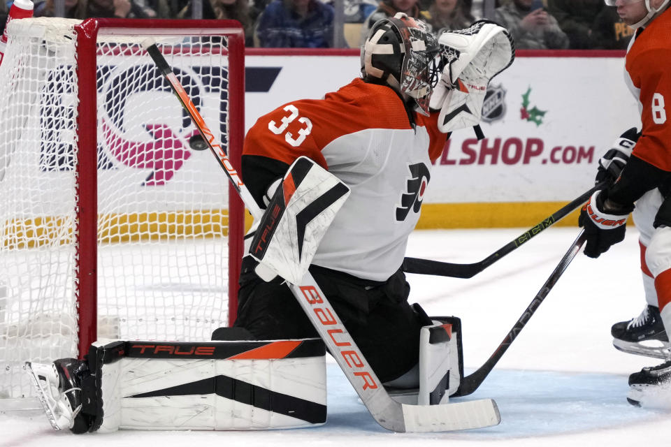 A shot by Pittsburgh Penguins' Kris Letang (not shown) gets past Philadelphia Flyers goaltender Samuel Ersson (33) for a goal during the second period of an NHL hockey game in Pittsburgh, Saturday, Dec. 2, 2023. (AP Photo/Gene J. Puskar)