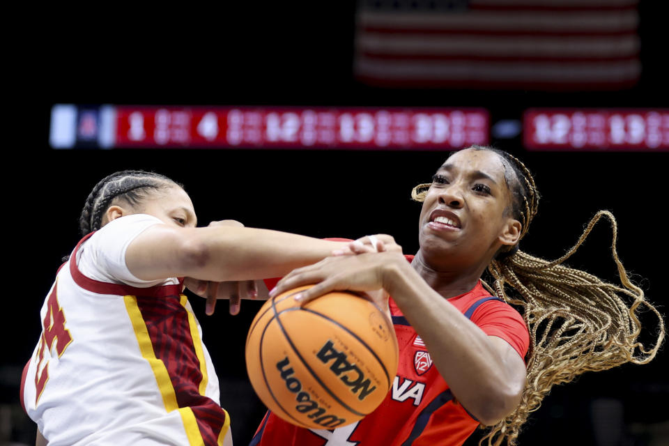 Southern California forward Kaitlyn Davis, left, attempts to steal the ball from Arizona guard Skylar Jones, right, during the first half of an NCAA college basketball game in the quarterfinal round of the Pac-12 tournament Thursday, March 7, 2024, in Las Vegas. (AP Photo/Ian Maule)