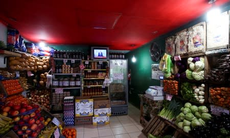 FILE PHOTO: Argentine President Mauricio Macri is seen on TV at a greengrocery in Buenos Aires