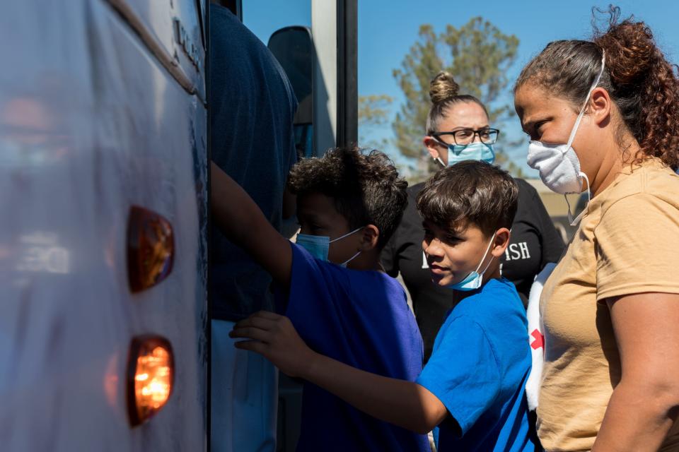 Migrants board a charter bus that will take them to their destination in New York. The City of El Paso and the Office of Emergency Management have managed a Migrant Welcome Center at the COVID Community Center in Northeast El Paso.