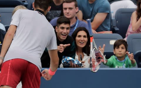 Dominic Thiem tosses his racket into the crowd - Credit: AP